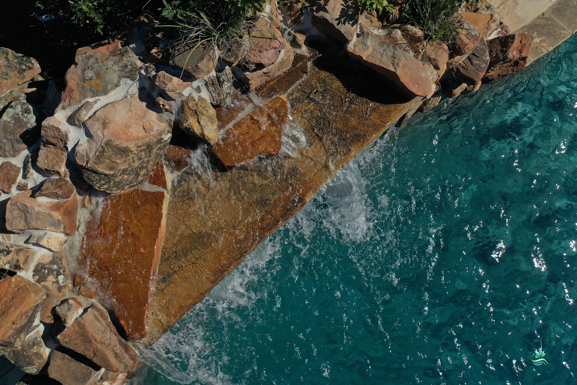 Balanced capstone over grotto waterfall